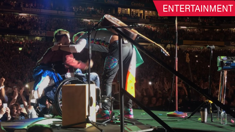 man on wheelchair performs with Coldplay onstage