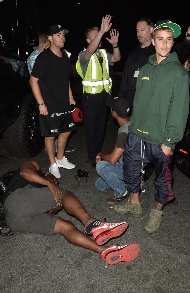 Justin Bieber with the photographer he accidentally ran over after leaving Hillsong
